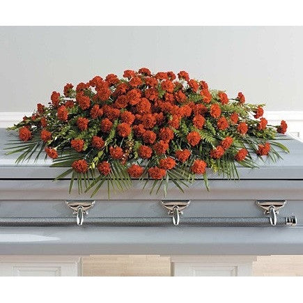 Red carnations full couch sympathy casket - Flowers by Pouparina